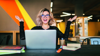 marymarkevich_freepik_funny-happy-excited-young-pretty-woman-sitting-table-black-shirt-working-laptop-co-working-office-wearing-glasses.jpg