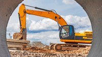 heavy-excavator-construction-site-view-excavator-through-iron-pipe-construction-equipment-earthworks-quarry-excavator.jpg