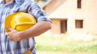 close-up-man-holding-his-head-protector-outdoors.jpg