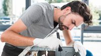 side-view-young-male-technician-working-broken-computer.jpg